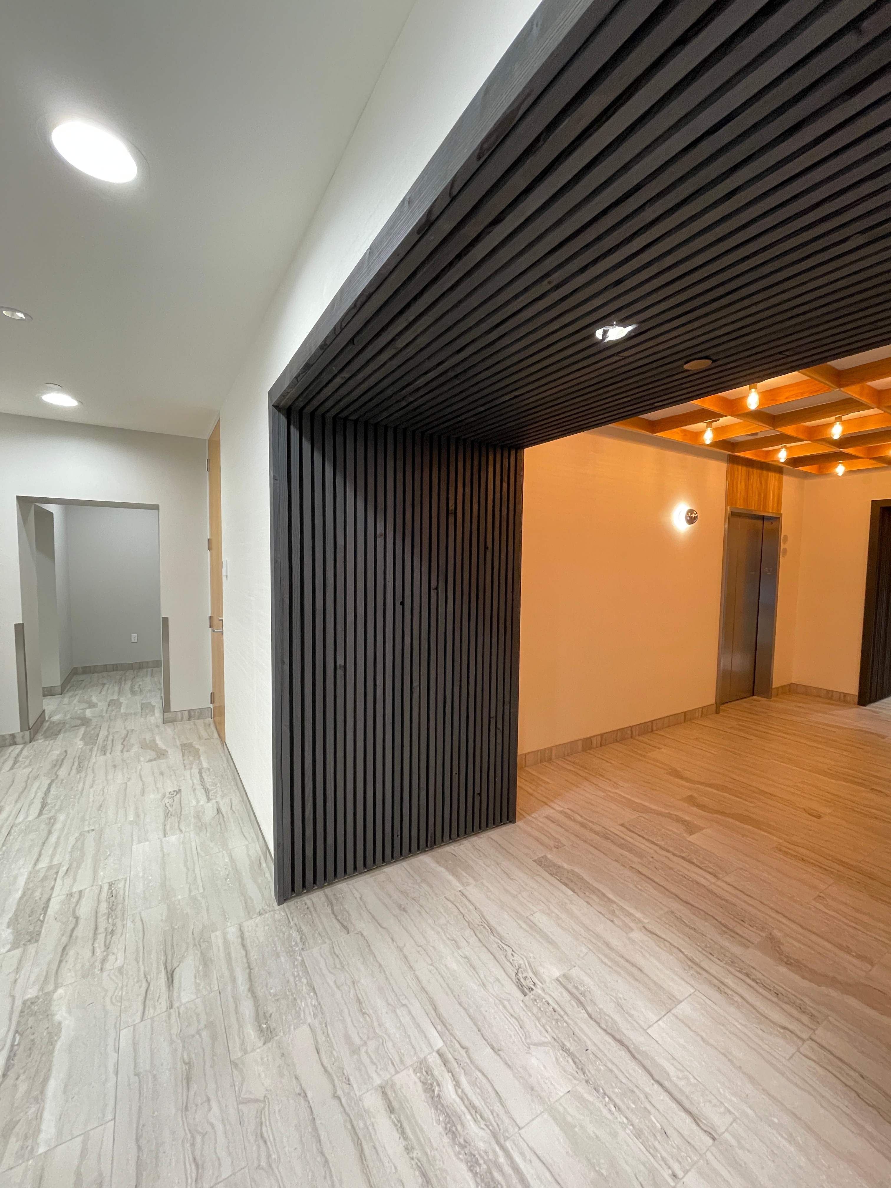 Finished interior renovation showing modern ceiling slats and clean wall installation in Kent home